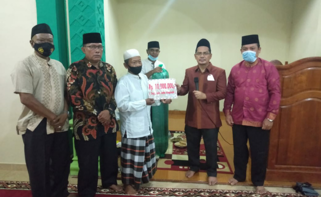 Ketua Tim Safari Ramadhan Kelompok VI,  H Adi Gunawan serahkan bantuan kepada pengurus Masjid Muhajirin Nagari Simalidu, Kecamatan Koto Salak.