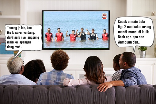 Multi generation family watching TV at home, back view